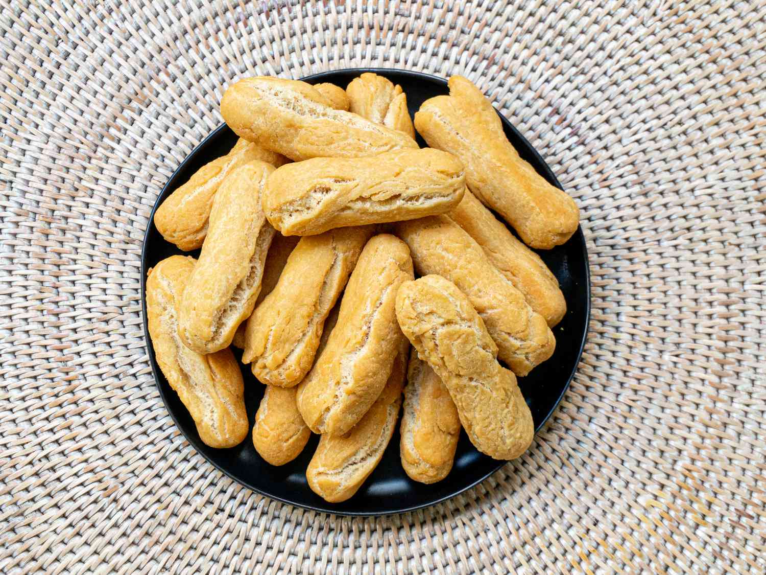 Overhead view of festivals on a black plate and wicker mat