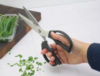 a person holding the shun shears