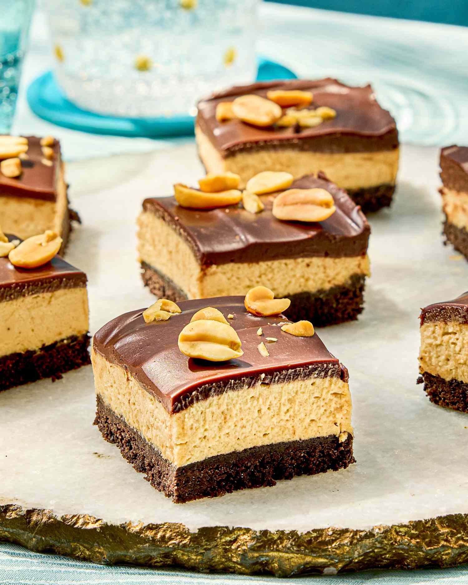 Peanut butter and chocolate dessert bars with peanuts on top