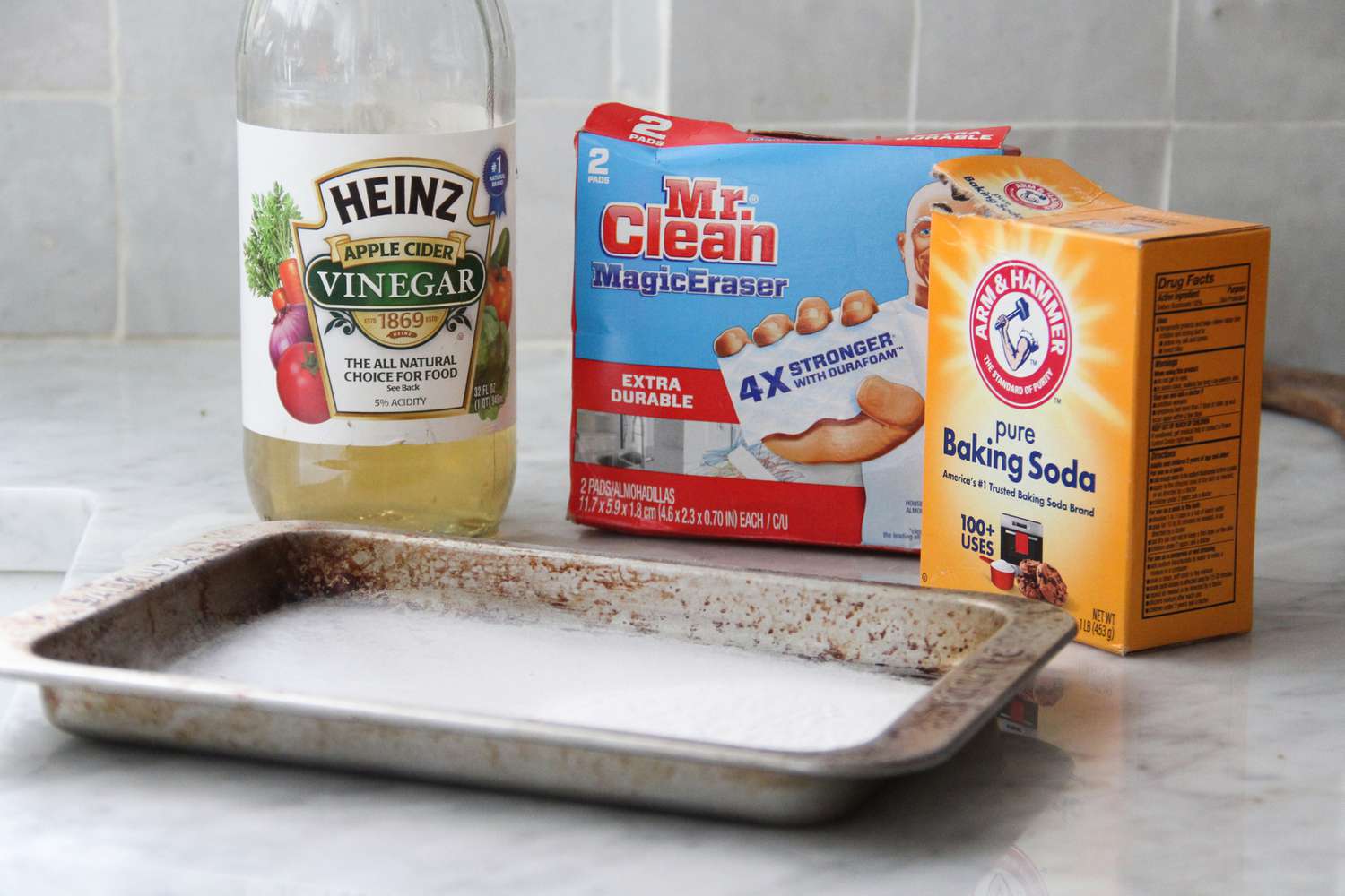 cleaning supplies behind a small toaster oven sheet tray