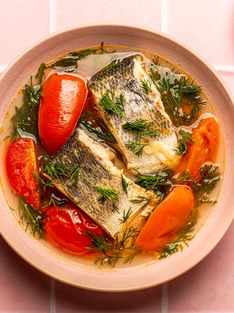Overhead view of soup on a pink, titled background