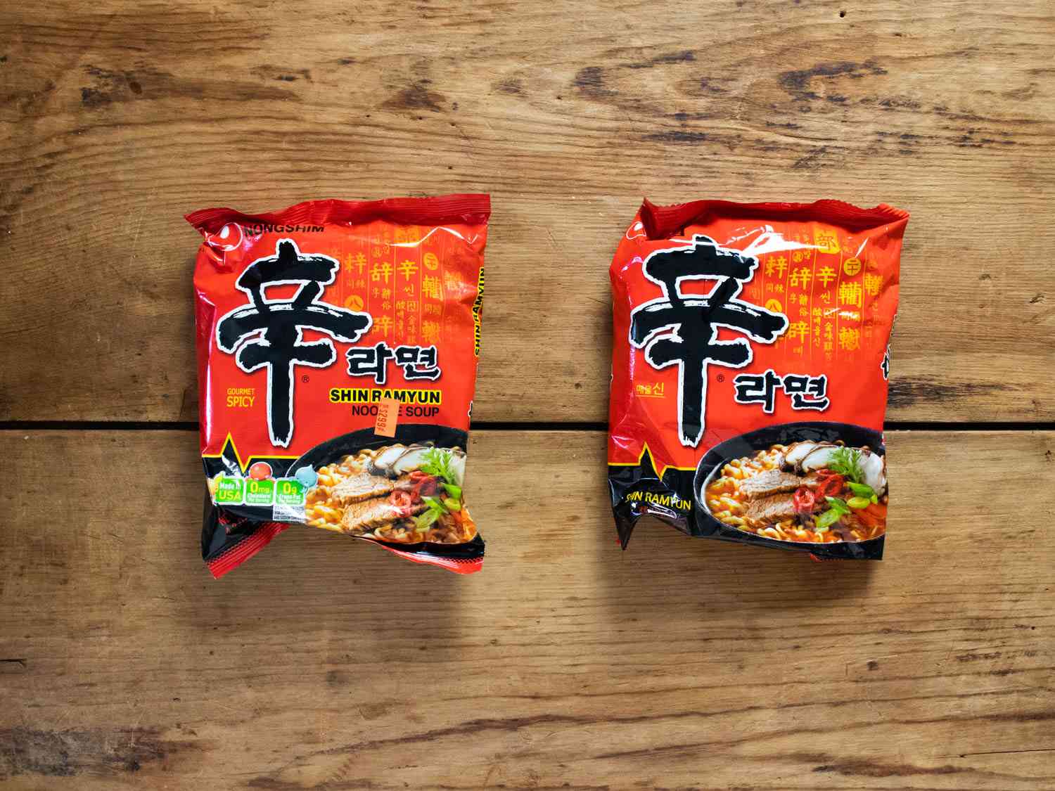 Korean and American Shin Ramyun Red packages side by side, with the Korean version on the right