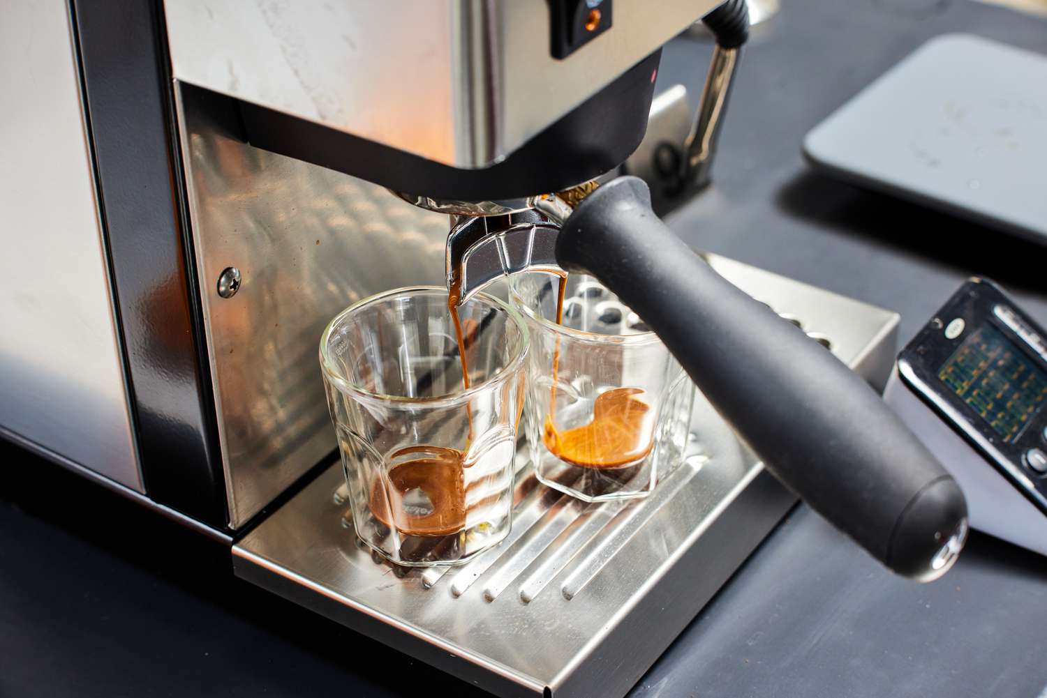 Close up of the Rancilio Silvia Espresso Machine brewing two espressos into glasses