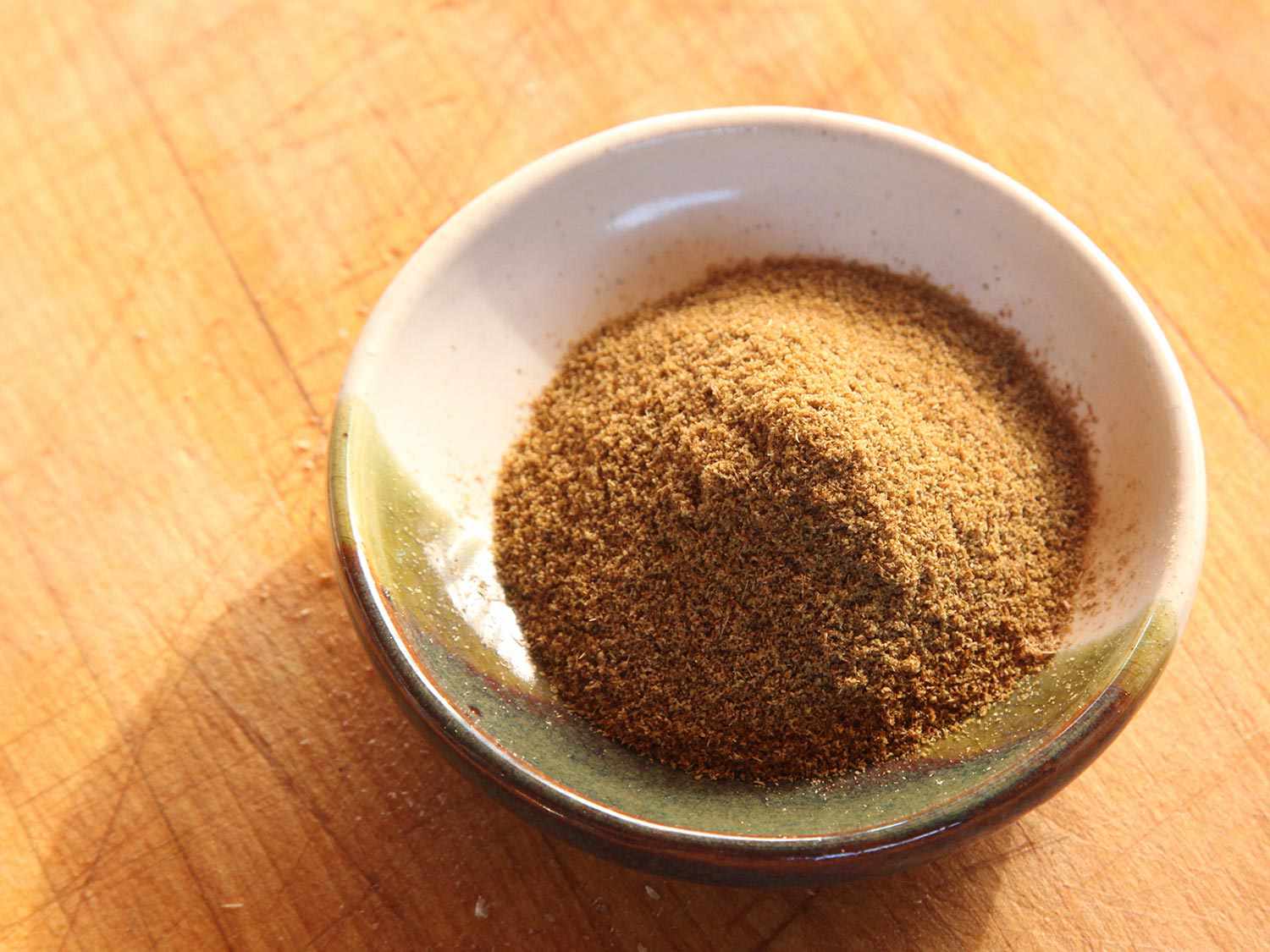Ground cumin and coriander seeds in a bowl.