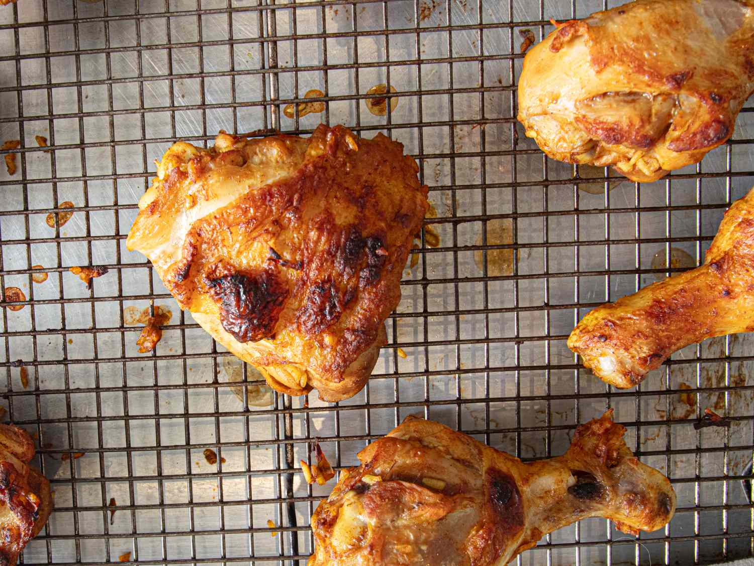 Cooked chicken pieces on a cooling rack