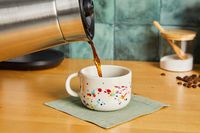 Coffee being poured into a Felt + Fat mug.