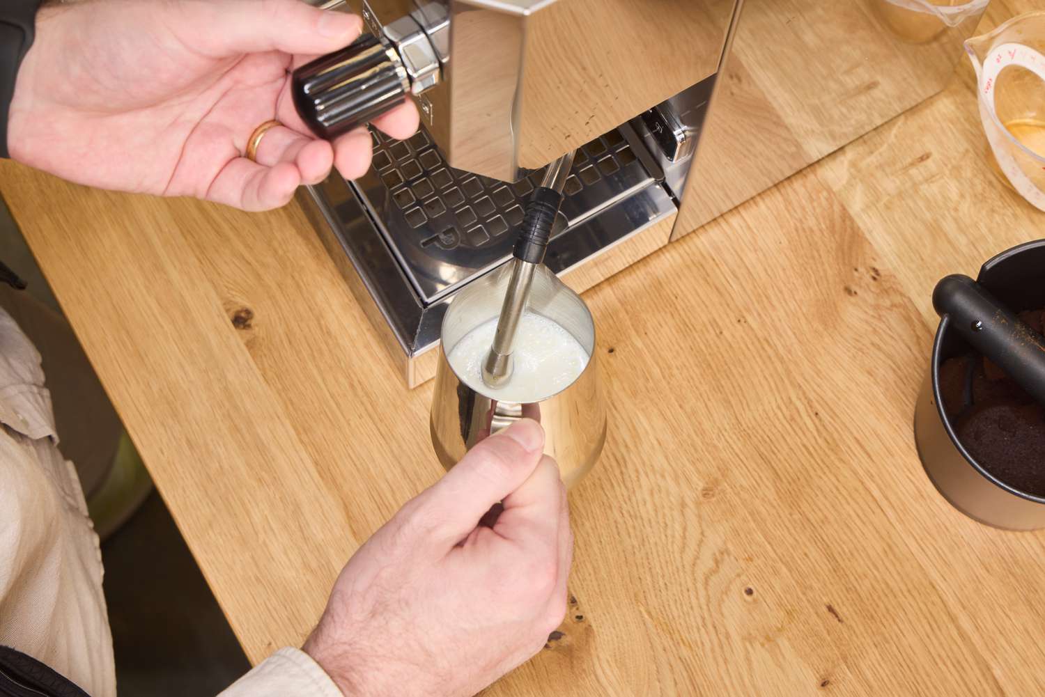 A person froths milk using the Profitec GO Single Boiler Espresso Machine steam wand