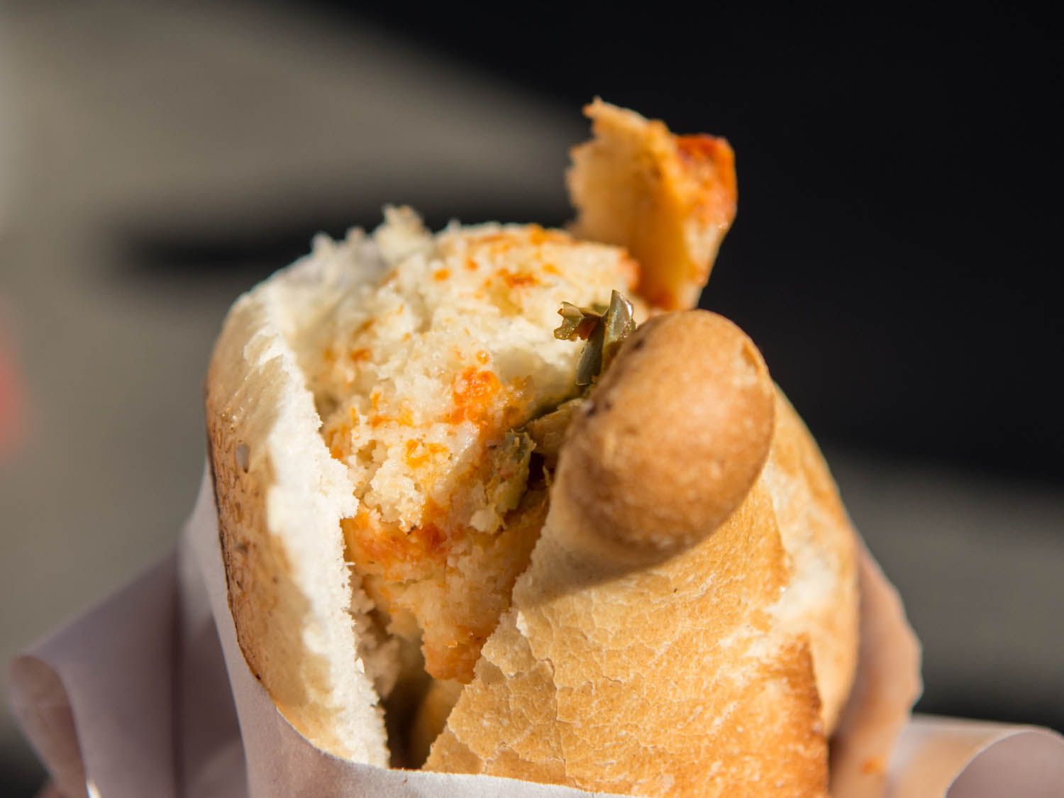 close-up of a guajolota-torta-tamal or tamal stuffed into bolillo roll