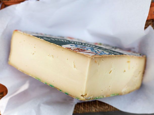 A cut quarter wheel of Fontina d'Aosta Cheese