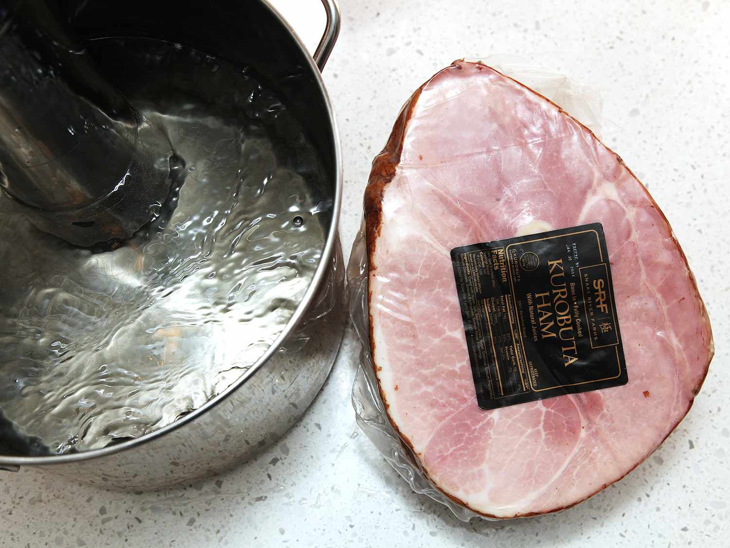 A package of ham and a sous vide pot next to it. 