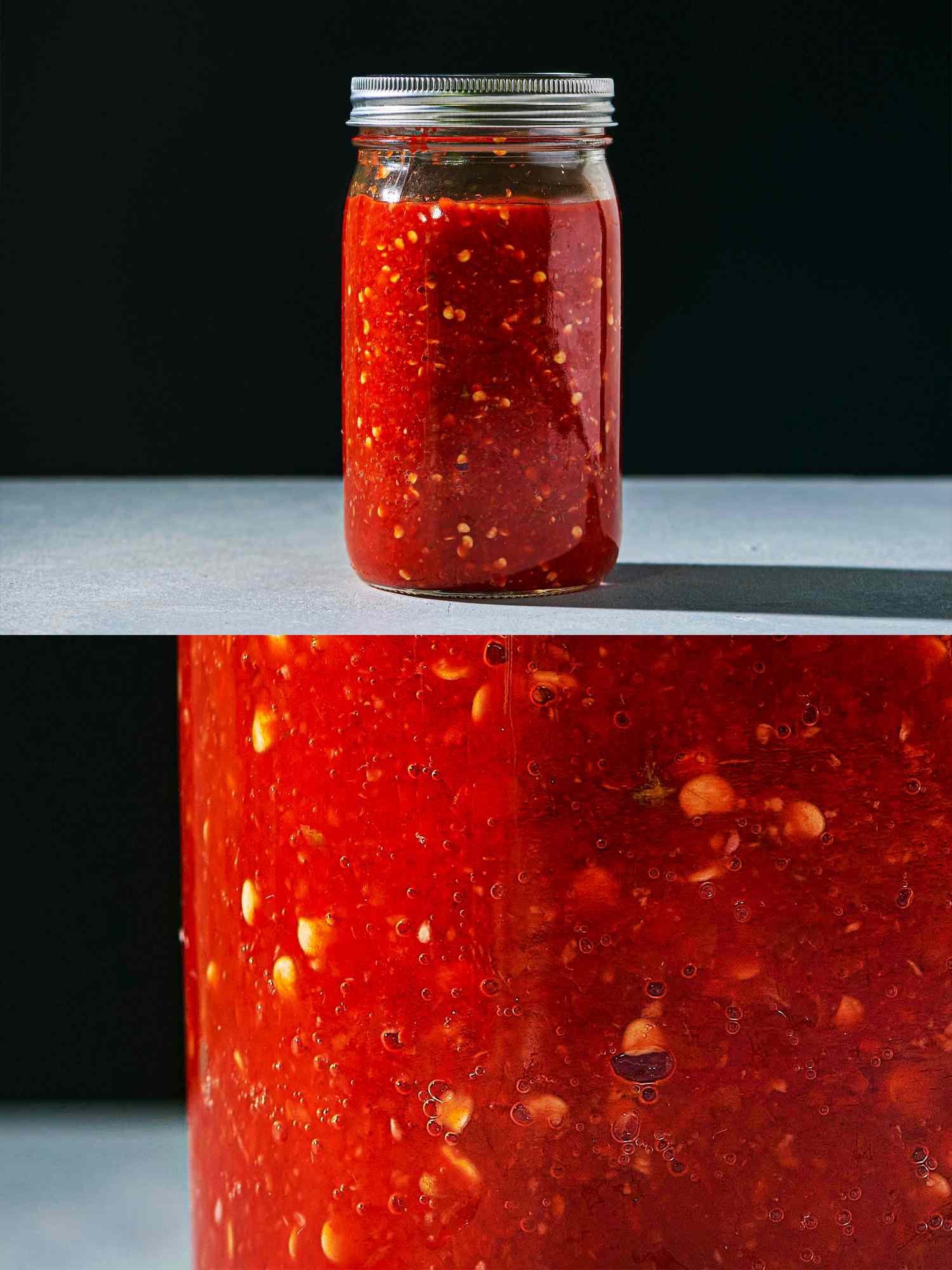 Bubbles forming within a jar of homemade sriracha