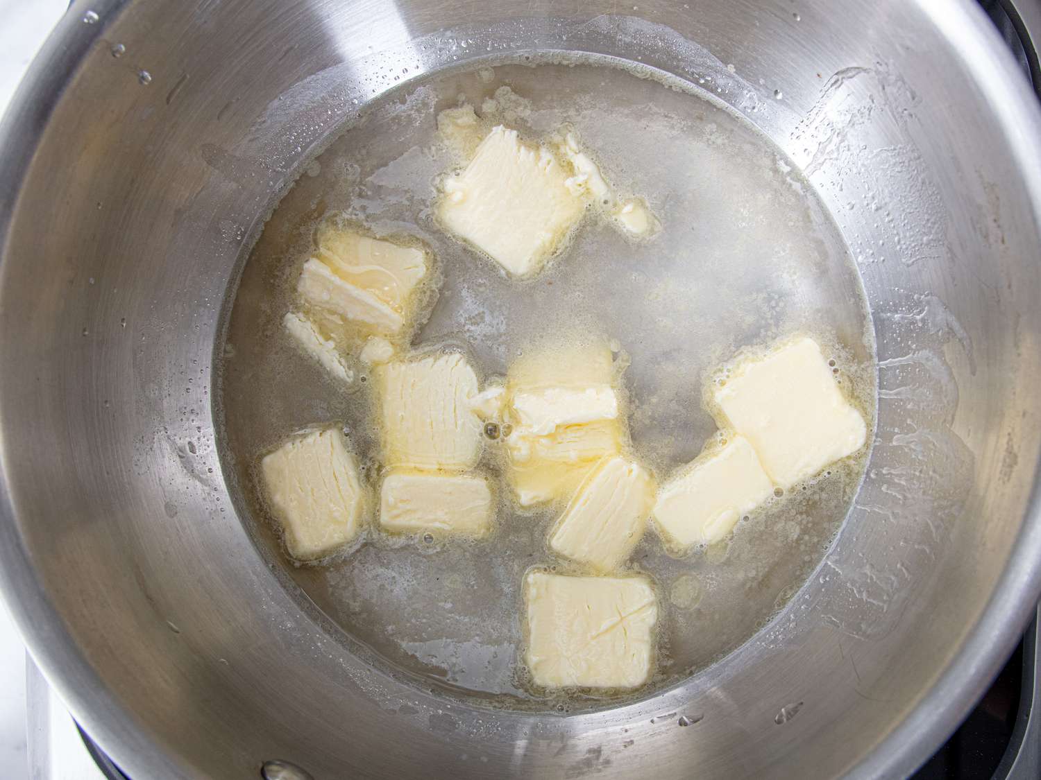 Overhead view of butter melting in water