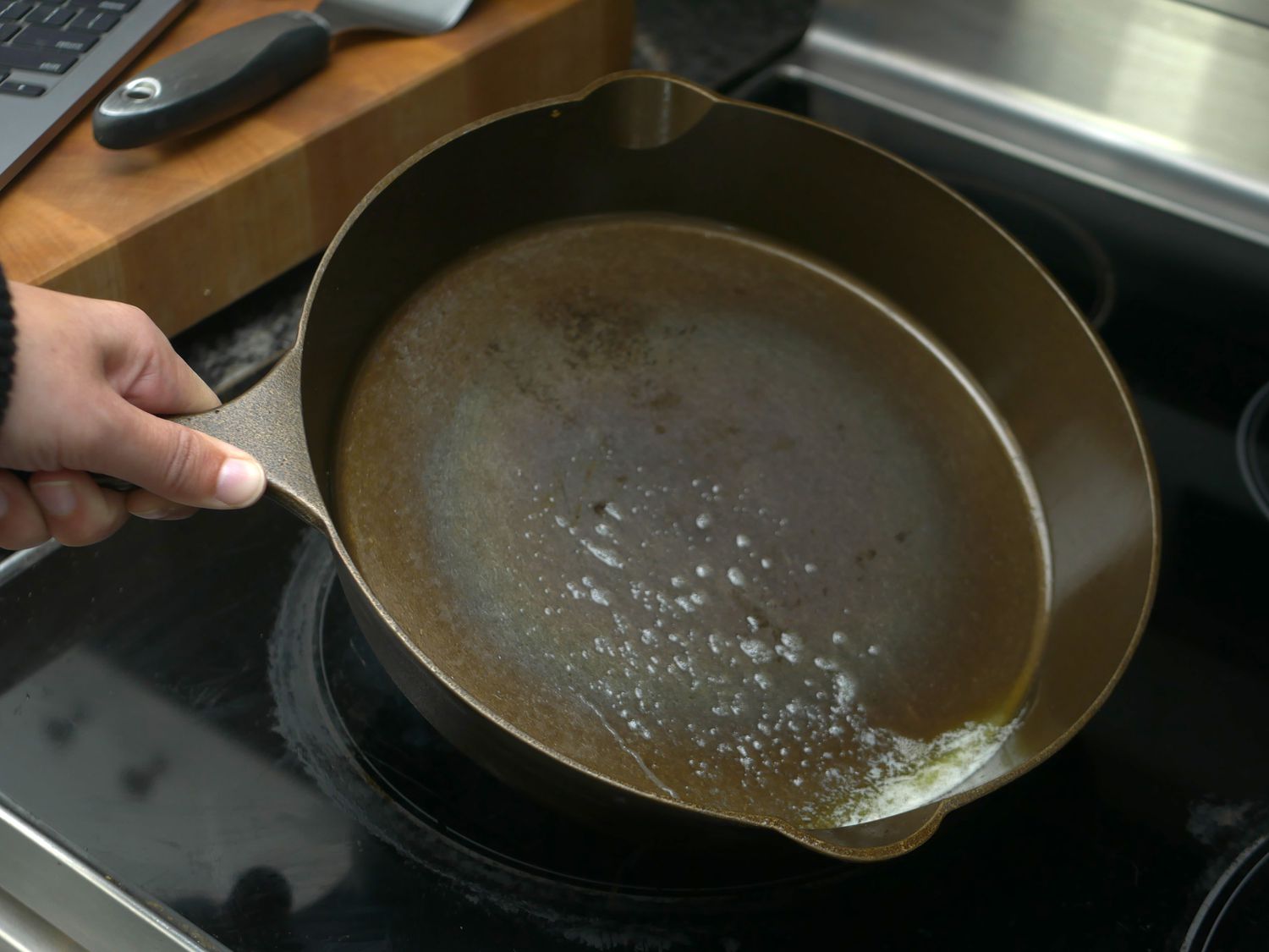 hand swirling melted butter in skillet