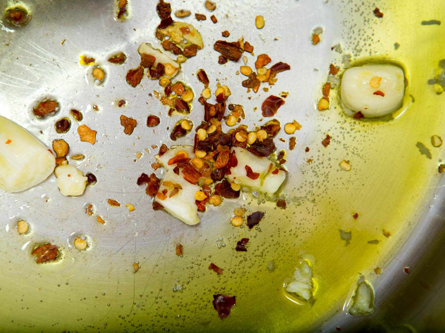 Sauteing garlic and red pepper flakes in olive oil.