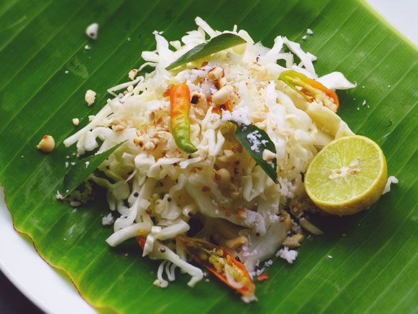 Quick Indian Cabbage Salad on a banana leaf with half a lime. 