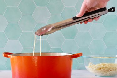 Hand picking up pasta from a pot using the OXO Good Grips 12-Inch Tongs