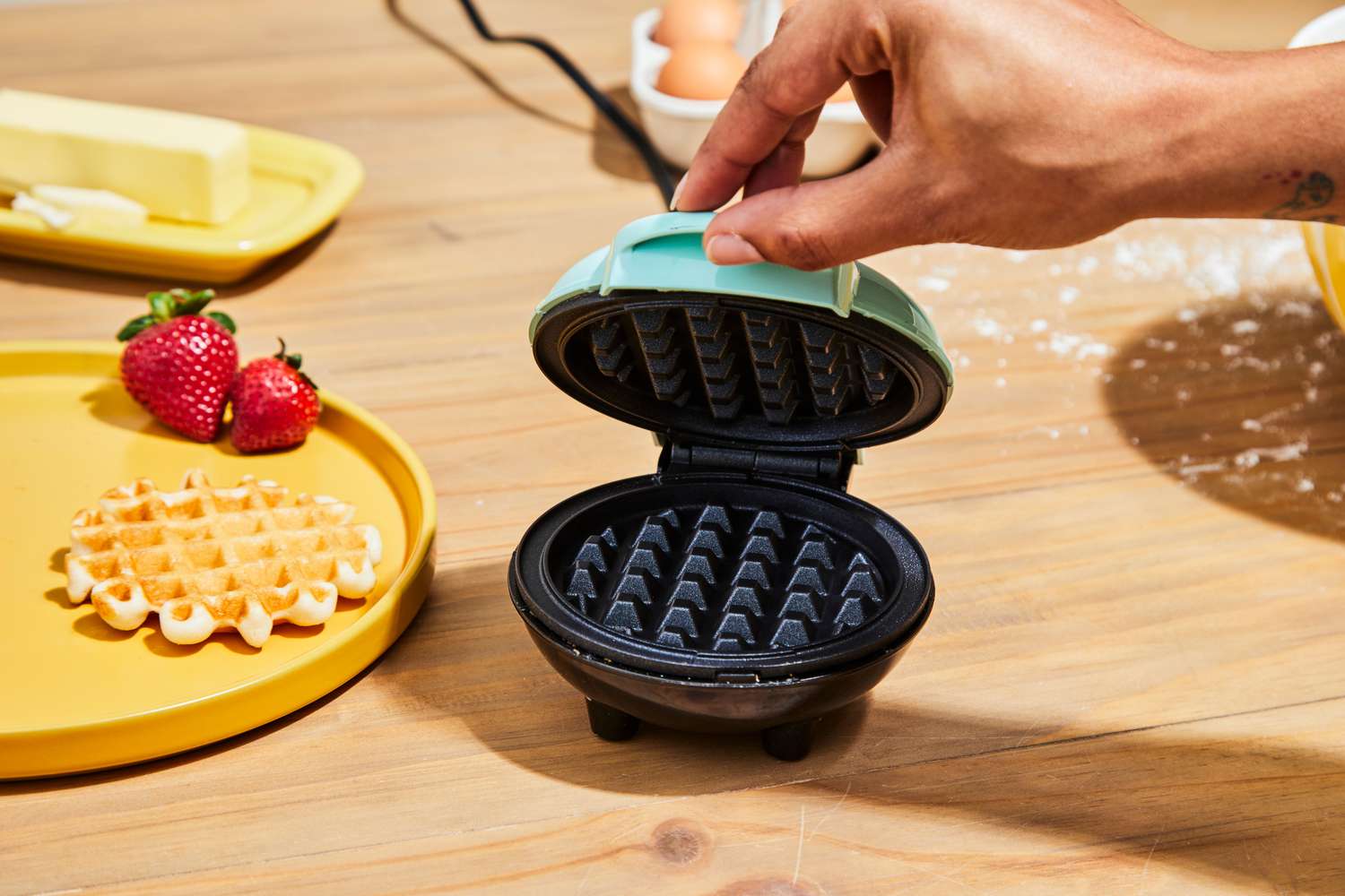 Person holding open Dash Mini Waffle Maker