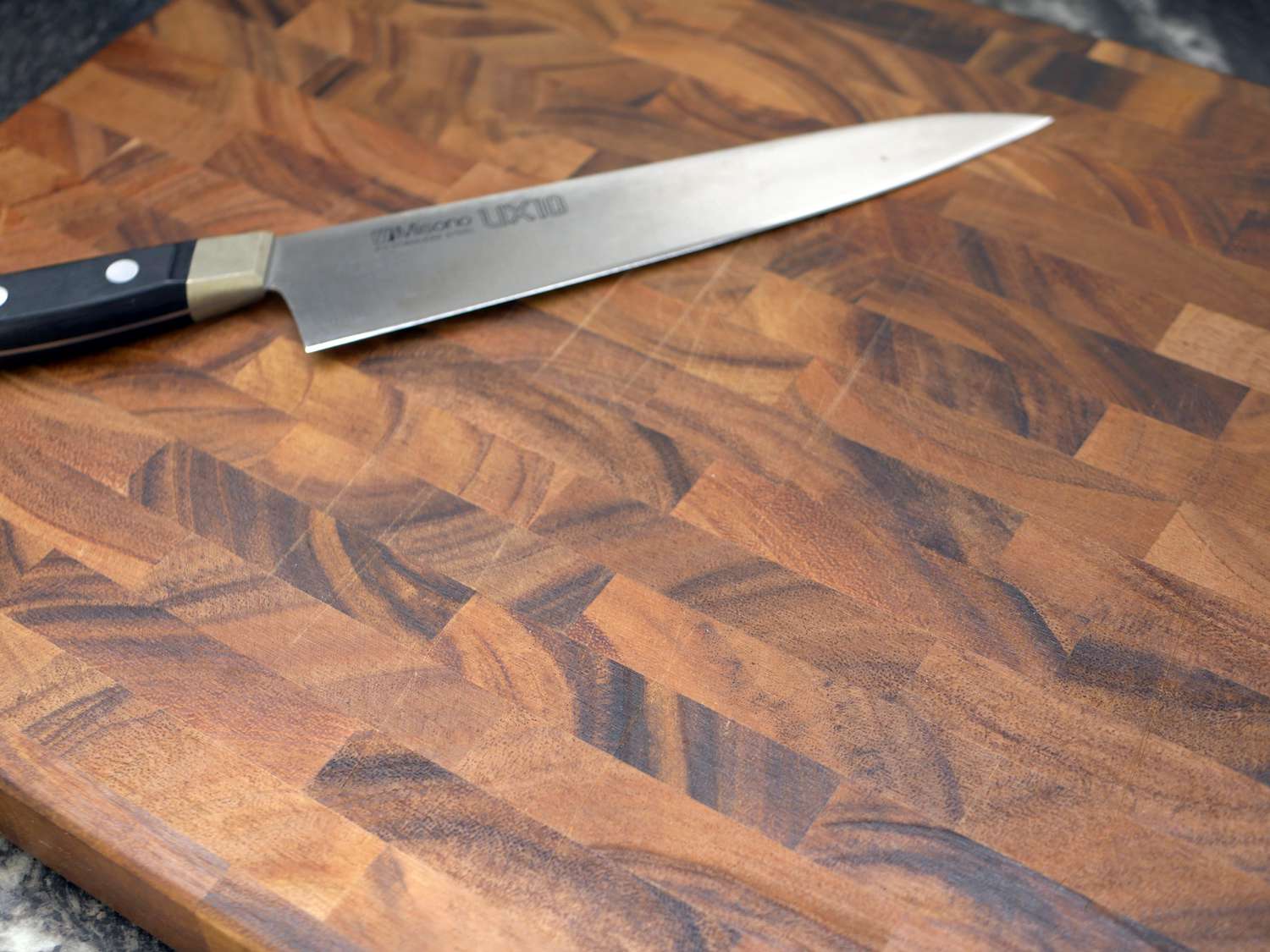 the ironwood acacia board with some visible knife scratches