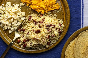 Gallopinto served with warm corn tortillas, scrambled eggs, and queso fresco on the side