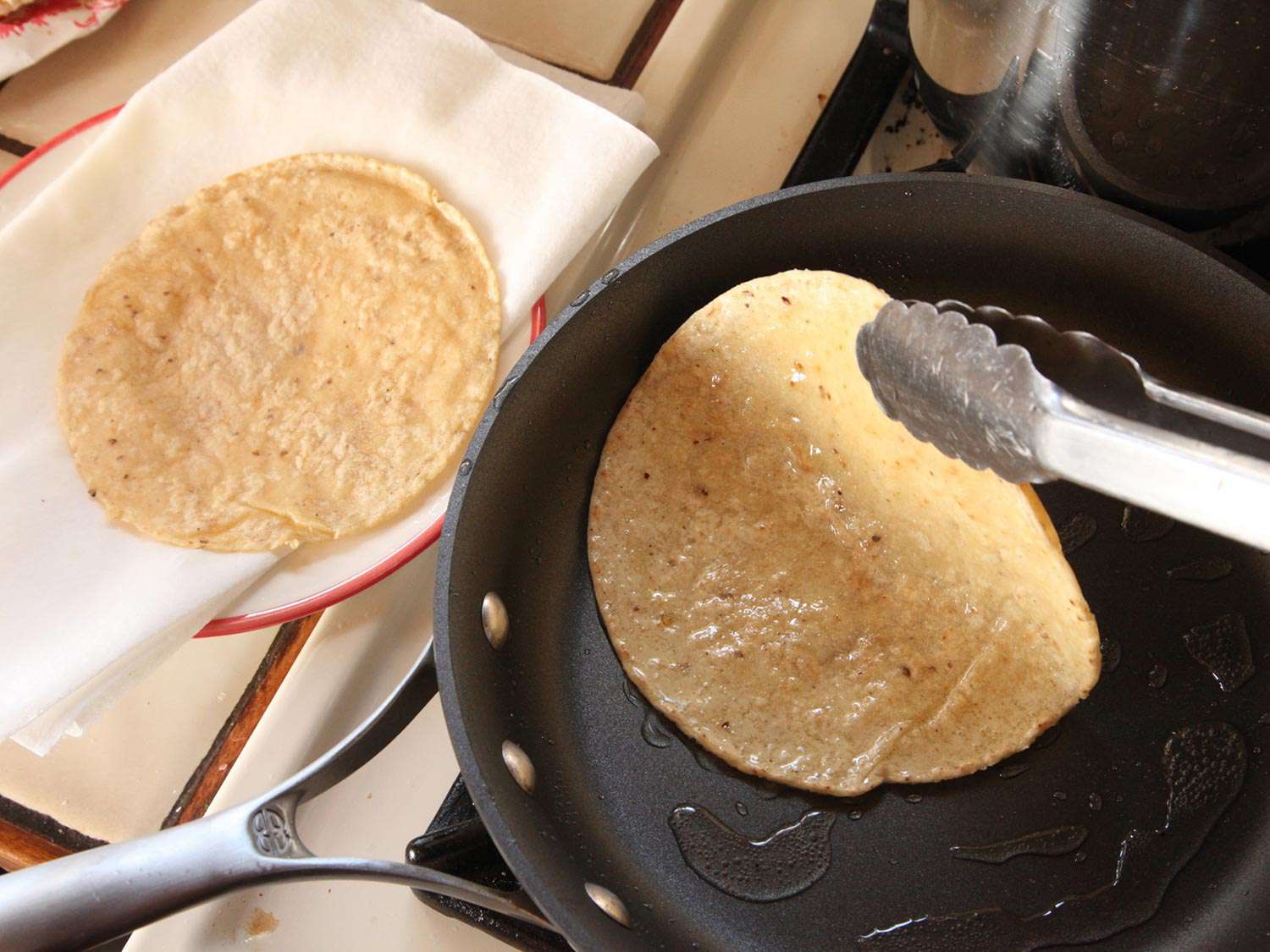 Corn tortillas are briefly fried in a nonstick skillet.