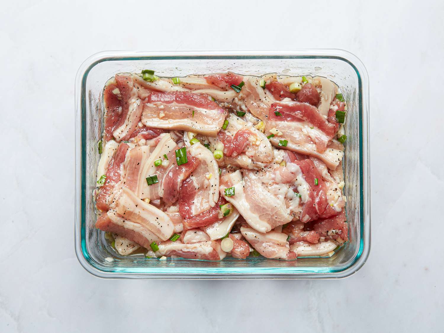 Pork belly marinating in a bowl