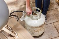 A hand connection the Gozney Roccbox Pizza Oven to a fuel tank