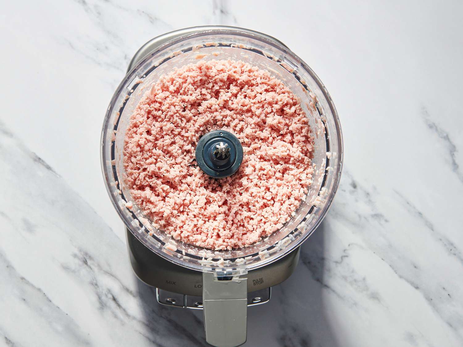 Overhead view of meat in food processor 