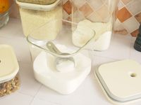 the scoop inside a container with sugar