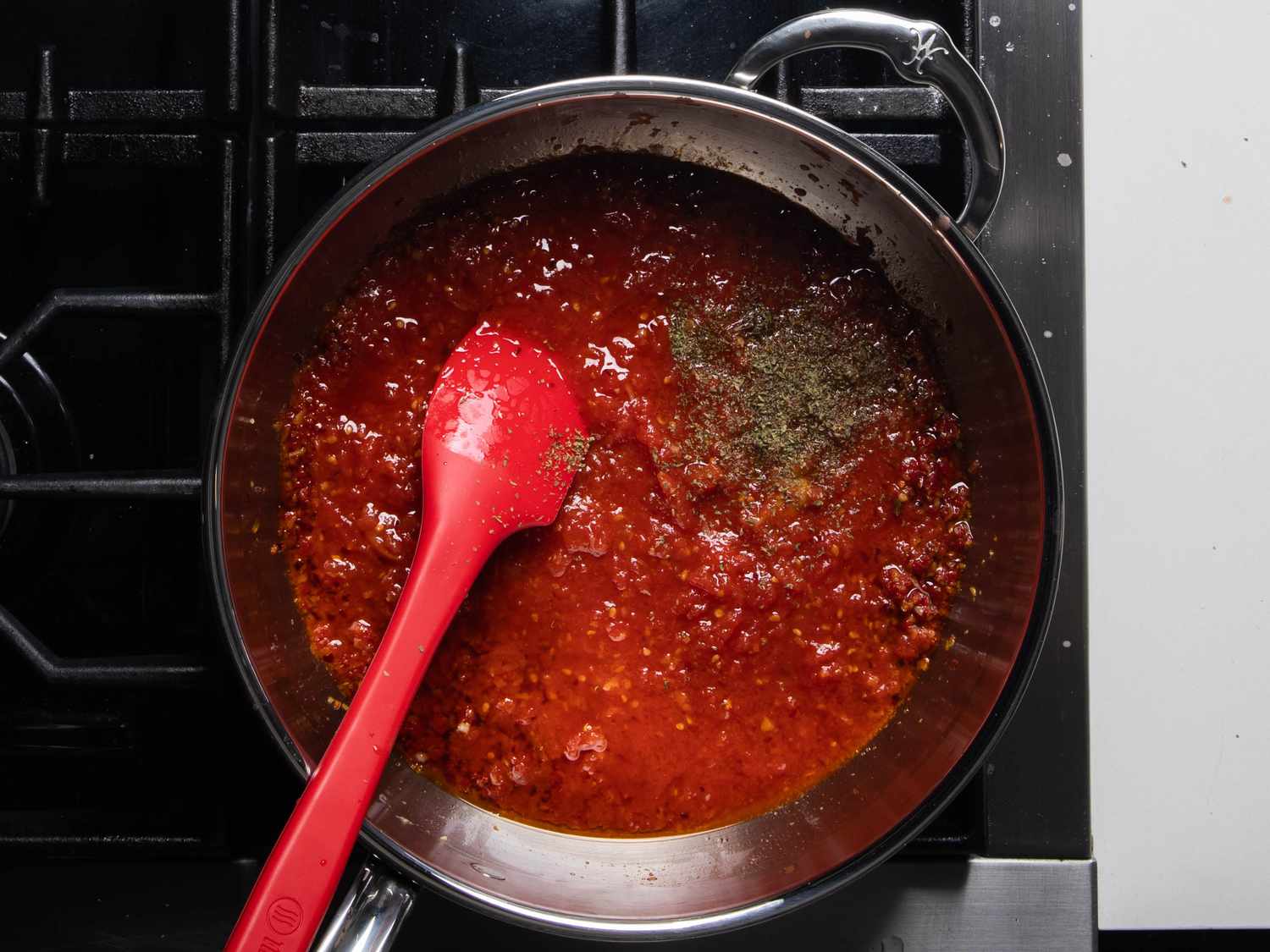 Tomatoes and oregano go into the pan.