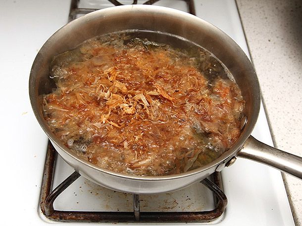 Making dashi: a saucepan of boiled kombu, topped with katsuobushi.