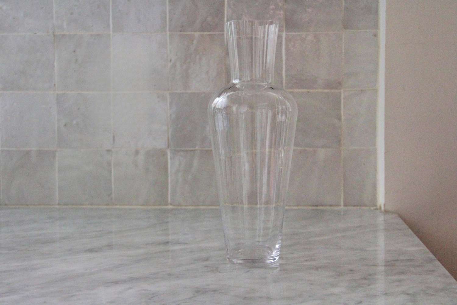 A closeup of the empty Riedel Wine Friendly wine decanter on a marble counter