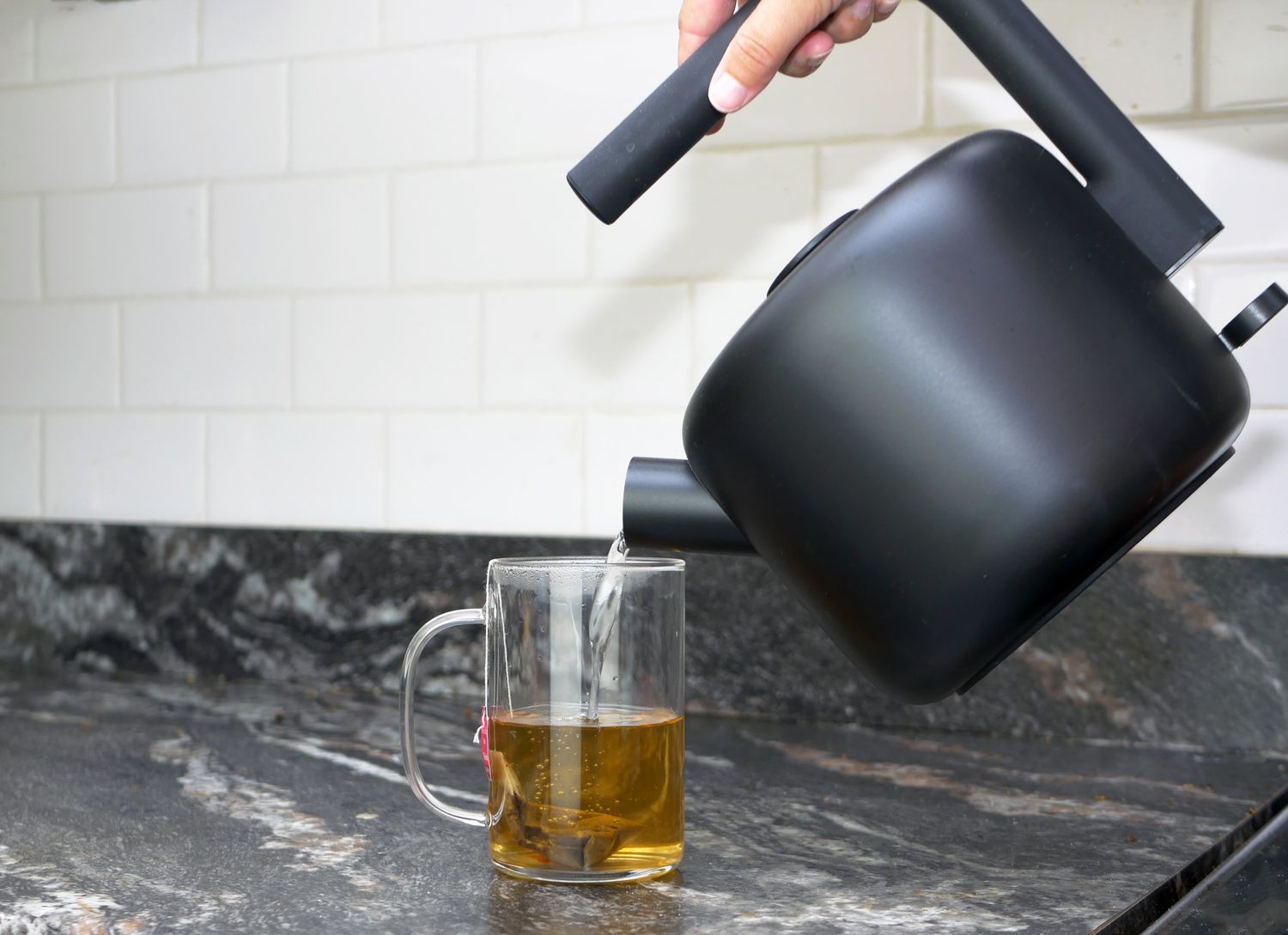 pouring water out of the fellow clyde non-variable kettle into a cup of tea