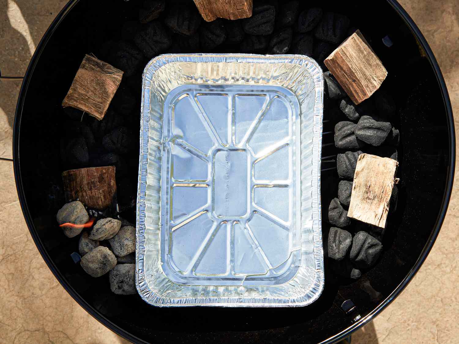 Overhead view of foil pan added to grill set up