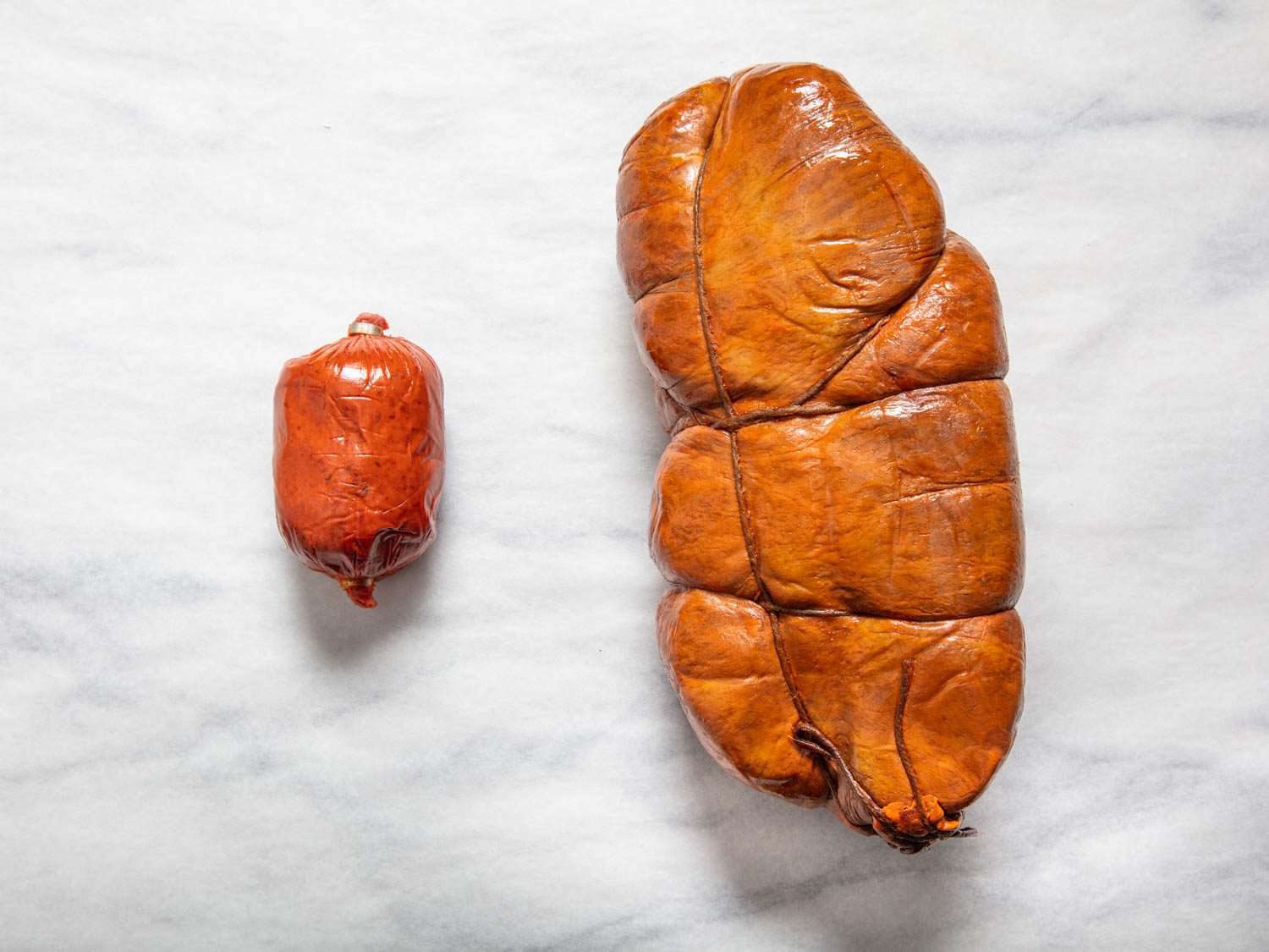 On the left, a small, commercially available Tempesta 'nduja. On the right, an enormous orba hung to age for much longer.