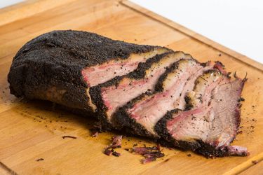 Sliced brisket on a cutting board. 