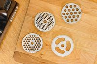 Grinding plates displayed on wooden board