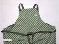 hexclad crossback apron on a white tile surface