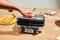 Person opening All-Clad 4-Square Digital Gourmet Waffle Maker