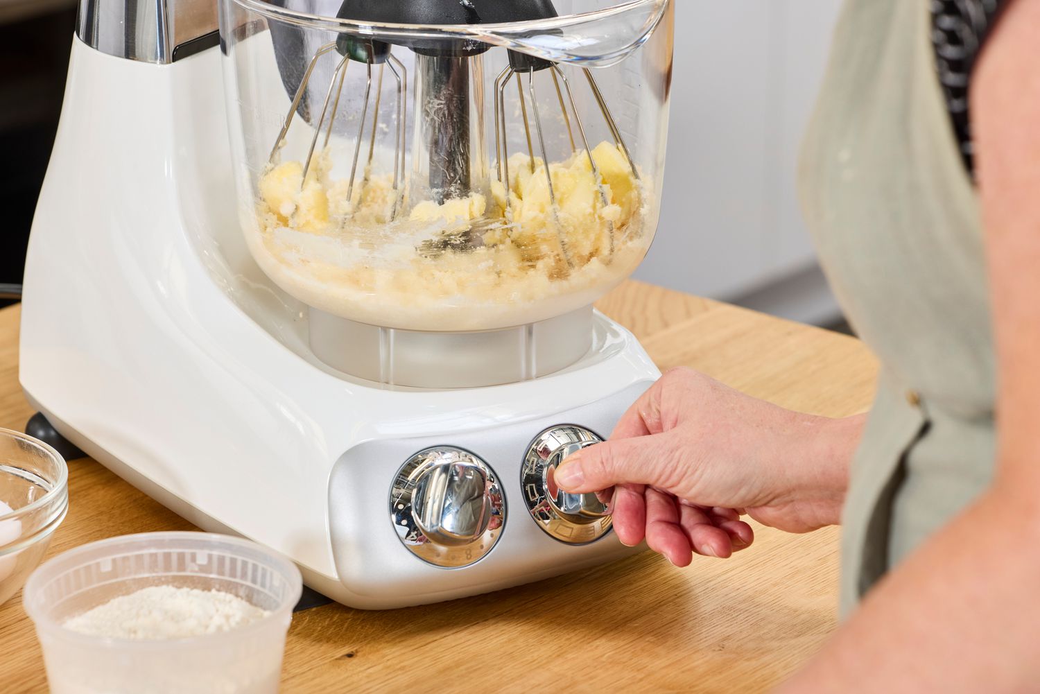 Tester adjusting Ankarsrum Stand Mixer's speed dial.