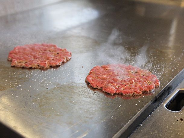 Seasoned smashed patties on the griddle