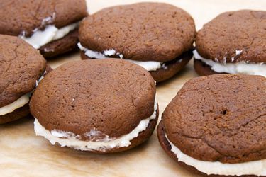 Gingerbread whoopie pies, assembled on a wooden work surface.