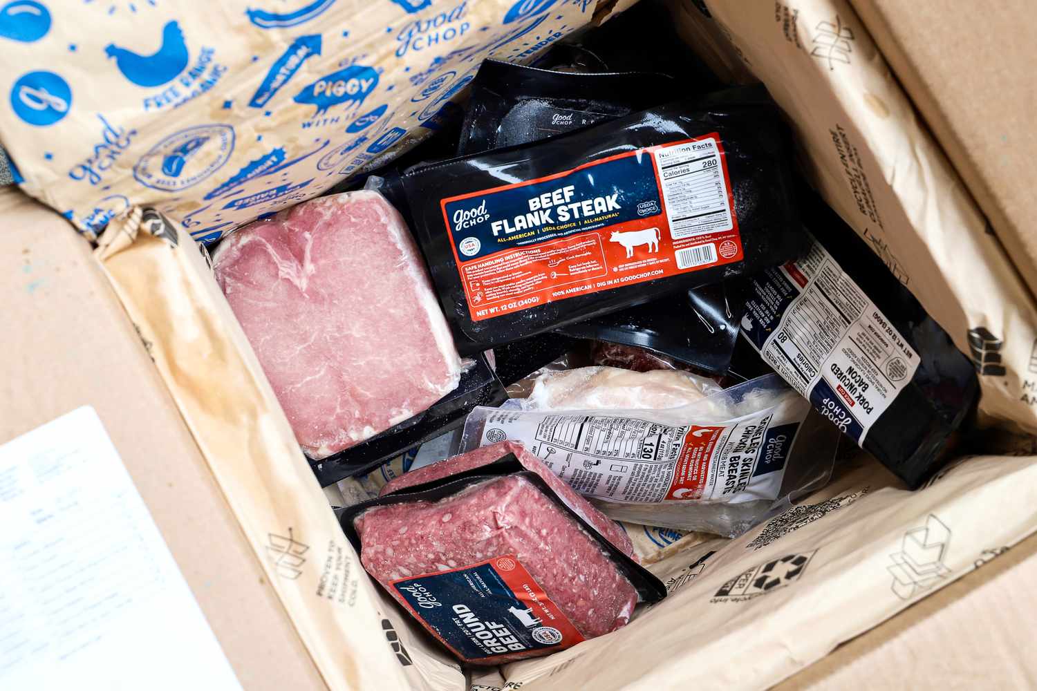 Packaged Good Chop cuts of meats and other food products in a box with branding visible