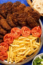 Overhead view of kotlets with tomatoes and french fries