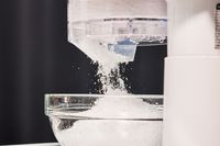 a closeup look at a shaved ice machine shaving ice