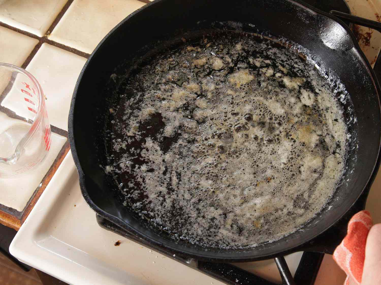 Butter browning in a cast iron skillet on stove