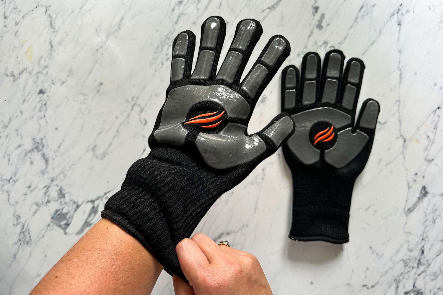A person puts on a Blackstone Griddle Glove