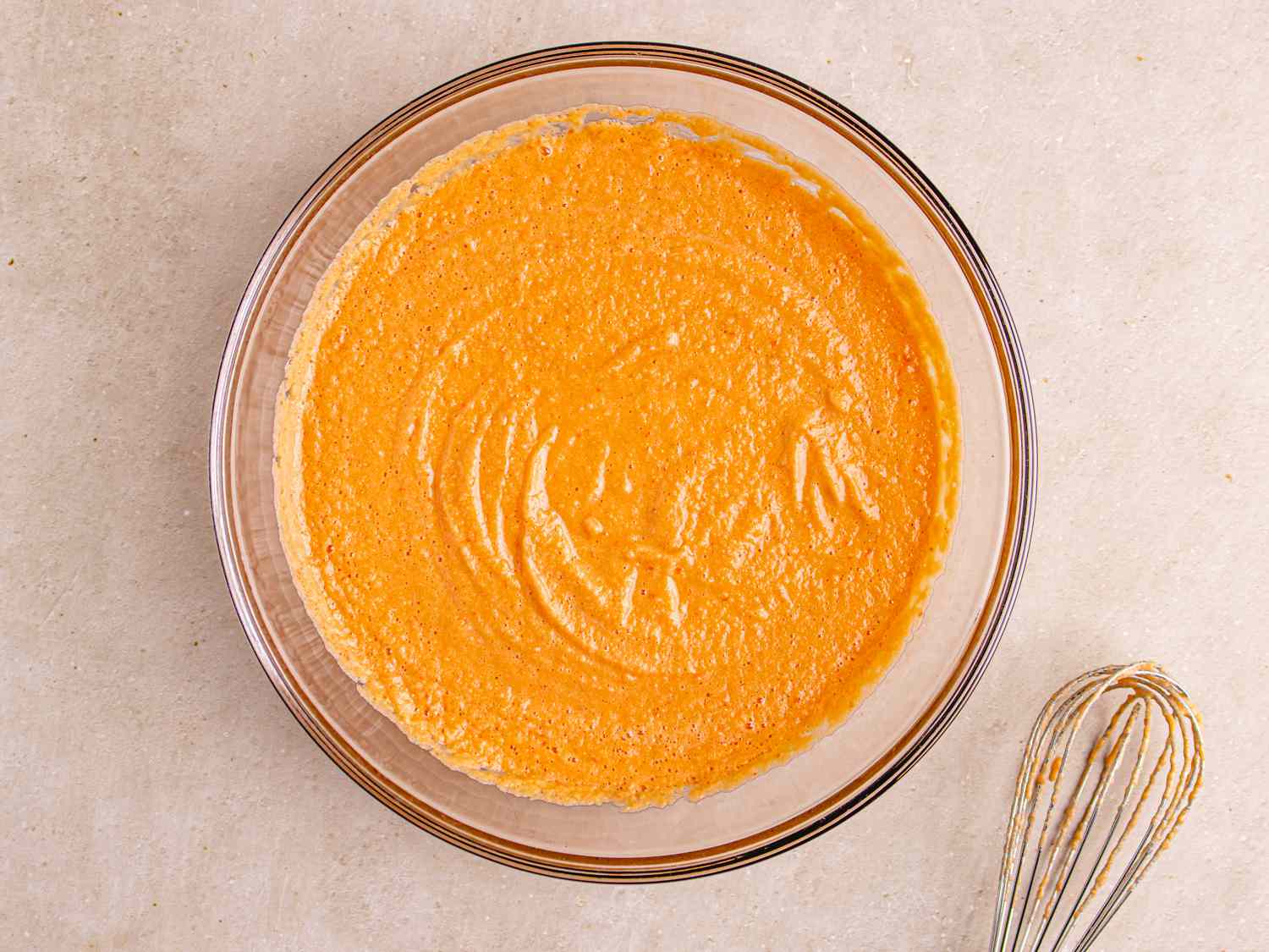 OVerhead view of puree in a bowl with a whisk