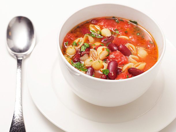 A bowl of quick pasta and bean soup with kidney beans and a tomato broth.