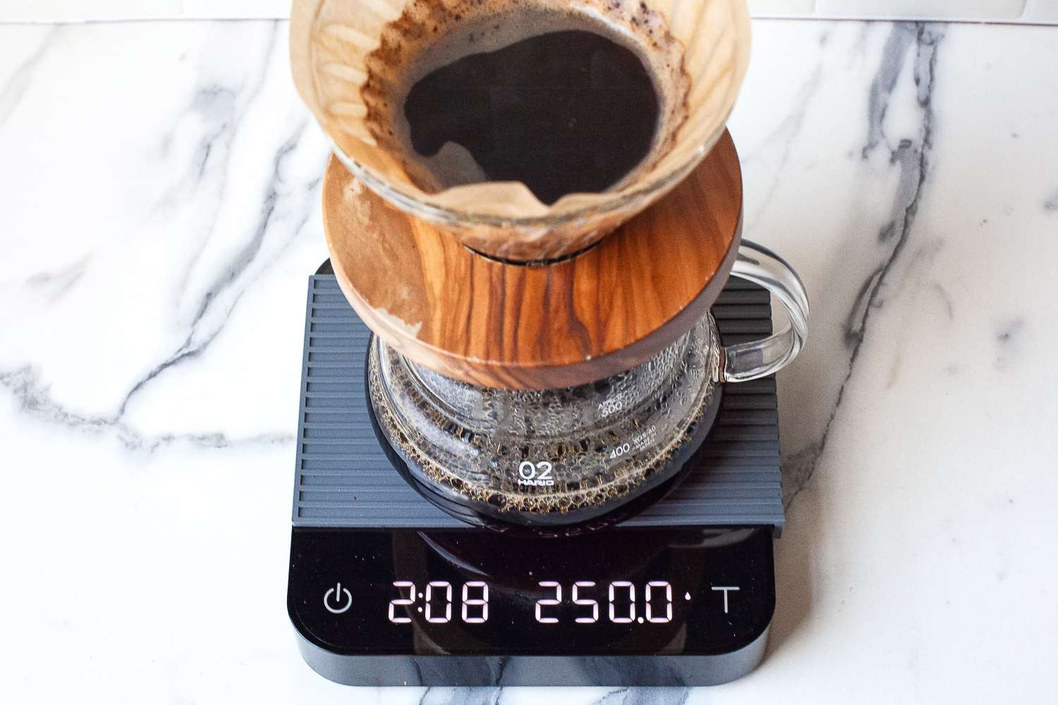 Pour-over coffee maker on Acaia Pearl scale with elapsed time and weight displayed