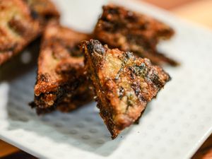 Plated triangles of Thai fried chive rice cakes
